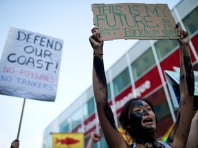 Jacqueline Lee-Tam wears face paint to simulate oil while attending a rally held to show opposition to the Enbridge Northern Gateway pipeline in Vancouver on Tuesday June 17, 2014.