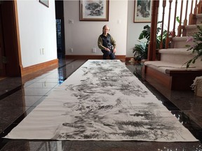 Taiwanese-Canadian artist John Chen with a portion of his 252-metre long watercolour.