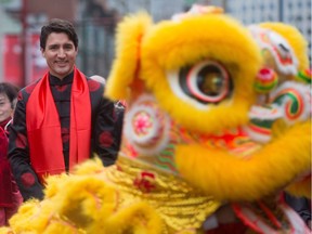 Prime Minister Justin Trudeau, back left, watches a lion dance team perform after participating in an eye-dotting ceremony before the Chinese Lunar New Year parade in Vancouver, B.C., on Sunday, January 29, 2017.