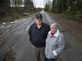 Eugene and Betty Nelson, who have lived at the corner of 216th Street and Telegraph Trail in Langley Township since 1991, stand on 216th Street. The little-used road will be the site of a four-lane highway interchange when construction starts in the spring.