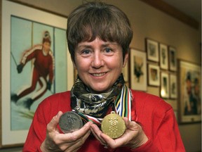 Nancy Greene Raine holds up her gold and silver ski medals from the 1968 Winter Olympics in Grenoble, France.