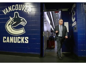 Head coach Willie Desjardins of the Vancouver Canucks leaves the dressing room before their NHL game against the Nashville Predators. The Canucks won 1-0.