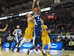 LANGLEY,BC:MARCH 12, 2016 -- Kelowna's Parker Simson drives to the basket with Tamanawis' Gary Sahota trying to defend during the 2016 Boys 'AAAA' High School Basketball Championships at the Langley Event Centre in Langley, BC, March, 12, 2016. (Richard Lam/PNG) (For Howie Tsumura) 00042192A [PNG Merlin Archive]