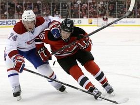 Reid Boucher (right) tries to get a step on Montreal Canadiens defenceman Alexei Emelin during Boucher's NHL debut for the New Jersey Devils in 2013.