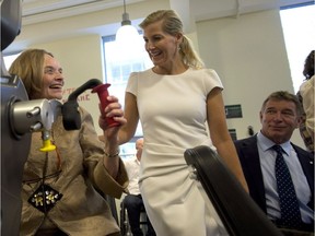 Rick Hansen looks on as Sophie Rhys-Jones, Countess of Wessex, tours the Blusson Spinal Cord Centre at Vancouver in September 2014.