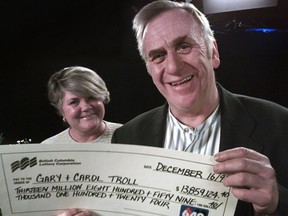 Carol and Gary Troll of West Vancouver hold their lottery winnings of $13,859,124.40 during a presentation ceremony in Richmond in 1996.