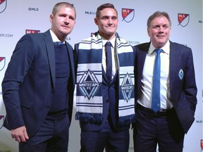 University of Connecticut fullback Jake Nerwinski, centre, poses with Vancouver Whitecaps head coach Carl Robinson, left, and president Bob Lenarduzzi after being taken seventh overall by the Whitecaps at the MLS SuperDraft in Los Angeles on Friday, Jan. 13, 2017.