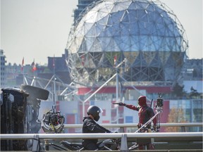 Character from the movie Deadpool, starring Ryan Reynolds, is seen running and jumping over cars on the Georgia viaduct in Vancouver, B.C., April 7, 2015.