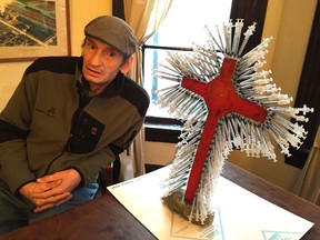Vancouver artist Randy Pandora with his Downtown Eastside cross, which is made from cardboard and hypodermic needles.
