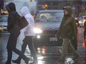 Heavy, cold rain fell on those out braving the weather at Burrard and Robson Street in Vancouver Sunday. A mix of rain and snow is in the forecast for B.C.'s South Coast over the next few days.