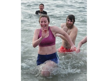 New Years' day revellers enjoy the annual Polar Bear Swim at English Bay in Vancouver, BC., January 1, 2017. After the initial swim in 1920 it reached a record attendance of 2,500 registered swimmers in 2014.