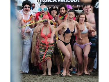 VNew Years' day revellers enjoy the annual Polar Bear Swim at English Bay in Vancouver, BC., January 1, 2017. After the initial swim in 1920 it reached a record attendance of 2,500 registered swimmers in 2014.