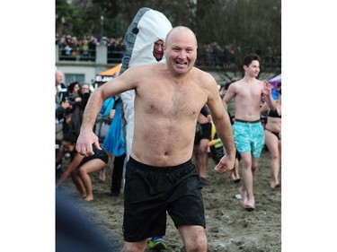 New Years' day revellers enjoy the annual Polar Bear Swim at English Bay in Vancouver, BC., January 1, 2017. After the initial swim in 1920 it reached a record attendance of 2,500 registered swimmers in 2014.