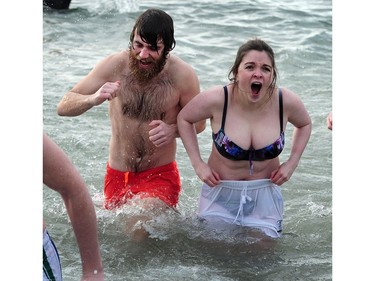 New Years' day revellers enjoy the annual Polar Bear Swim at English Bay in Vancouver, BC., January 1, 2017. After the initial swim in 1920 it reached a record attendance of 2,500 registered swimmers in 2014.