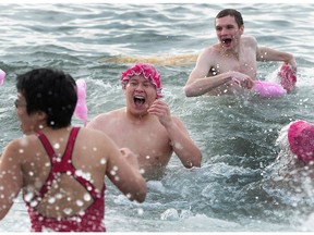 Participants run in and out of the frigid waters of English Bay during the Polar Bear Swim in Vancouver, B.C.