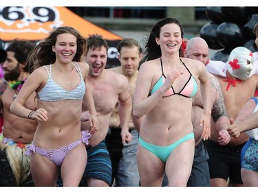 New Years' day revellers enjoy the annual Polar Bear Swim at English Bay in Vancouver, BC., January 1, 2017. After the initial swim in 1920 it reached a record attendance of 2,500 registered swimmers in 2014.