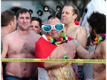 New Years' day revellers enjoy the annual Polar Bear Swim at English Bay in Vancouver, BC., January 1, 2017. After the initial swim in 1920 it reached a record attendance of 2,500 registered swimmers in 2014.