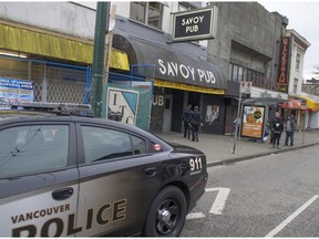 Vancouver police at the scene of a shooting death at the Savoy Hotel on E. Hastings Street in Vancouver.