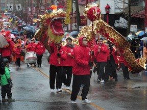 A traditional lion dance moves through the streets of Vancouver's Chinatown on Sunday during the 44th annual  Lunar New Year parade, which also featured cultural dance troupes and marching bands.