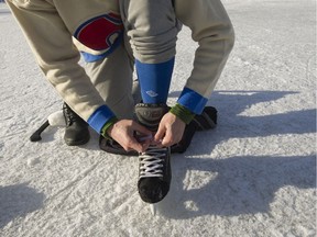 People ice skate and play hockey on Trout Lake in Vancouver, B.C., January 5, 2017.