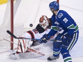 Vancouver Canucks centre Brandon Sutter (20) tries to get a shot past New Jersey Devils goalie Cory Schneider (35) during third period NHL action in Vancouver, B.C. Sunday, Jan. 15, 2017.