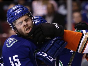 Vancouver Canucks' Michael Chaput (45) is grabbed by his lip by Anaheim Ducks' Nick Ritchie (37) during first period NHL hockey action in Vancouver on Friday, December 30, 2016.