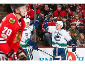 Troy Stecher celebrates a goal against the Blackhawks..