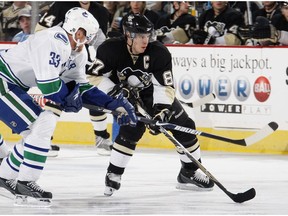 PITTSBURGH - NOVEMBER 22:  Sidney Crosby #87 of the Pittsburgh Penguins tries to get around Henrik Sedin #33 of the Vancouver Canucks on November 22, 2008 at Mellon Arena in Pittsburgh, Pennsylvania. Vancouver won the game 3-1.