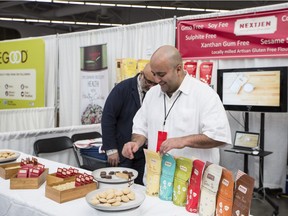 Chef Hamid Salimian, co-founder of NextJen Gluten-Free flour blends, arranges his products Sunday at the Specialty Food Expo in Vancouver.