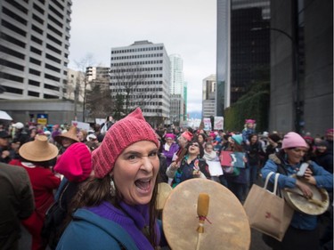 A woman sings and drums during a women's march and protest against U.S. President Donald Trump, in Vancouver, B.C., on Saturday January 21, 2017.