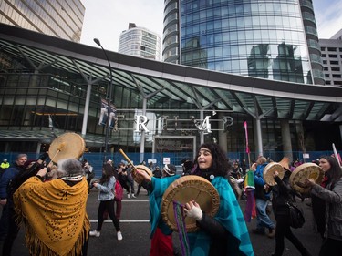 Women beat drums and chant as they march past the still under construction Trump International Hotel and Tower during a women's march and protest against U.S. President Donald Trump, in Vancouver, B.C., on Saturday January 21, 2017.