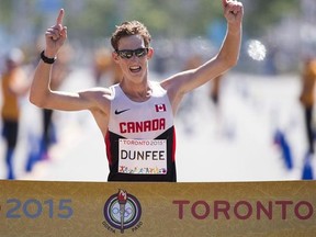 Canada&#039;s Evan Dunfee crosses the finish to win the men&#039;s 20km race walk at the Pan Am Games in Toronto, Ontario, Sunday, July 19, 2015. On the days Evan Dunfee hasn&#039;t injested enough fat, he&#039;ll melt butter in the microwave and then toss it back like tequila. THE CANADIAN PRESS/AP, Felipe Dana