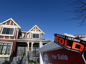 A real estate sold sign is shown outside a house in Vancouver, Tuesday, Jan.3, 2017. Home sales in Metro Vancouver last month dropped by almost 40 per cent compared with January 2016 with the sale of detached houses falling hardest. THE CANADIAN PRESS/Jonathan Hayward
