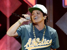 FILE - This Dec. 2, 2016 file photo shows Bruno Mars performing at the 2016 Jingle Ball in Los Angeles. Mars was in top formÂ at a pre-Super Bowl show in Houston Friday night, Feb. 3, 2017, matching the energy he showedÂ when he hit the stage at halftime last year and in 2014. (Photo by Chris Pizzello/Invision/AP, File)