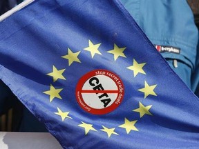 An anti-CETA sticker is pictured on an European flag during a demonstration against the so-called CETA trade deal outside the European Parliament in Strasbourg, eastern France, Wednesday, Feb.15, 2017. The European Union&#039;s parliament approved a trade deal with Canada, extolling the pact as a sign of cooperation at a time when many political forces, including U.S. President Donald Trump&#039;s administration, are trying to halt globalization.(AP Photo/Jean-Francois Badias)