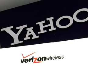 FILE - This Monday, July 25, 2016, file photo shows the Yahoo and Verizon logos on a laptop, in North Andover, Mass. Yahoo is taking a $350 million hit on its previously announced $4.8 billion sale to Verizon in a concession for security lapses that exposed personal information stored in more than 1 billion Yahoo user accounts. The revised agreement announced Tuesday, Feb. 21, 2017, eases investor worries that Verizon Communications Inc. would demand a discount of at least $1 billion or cancel t