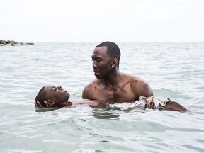 This image released by A24 shows Alex Hibbert, foreground, and Mahershala Ali in a scene from the film, &ampquot;Moonlight.&ampquot; (David Bornfriend/A24 via AP)