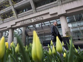 A man walks by the Manulife Centre in Toronto on the day of the Manulife Financial annual general meeting on Thursday, May 3, 2012. Manulife Financial Corp. confirmed Monday its banking unit was penalized last year after Canada&#039;s money-laundering watchdog concluded it failed to report a suspicious transaction and various money transfers. THE CANADIAN PRESS/Aaron Vincent Elkaim