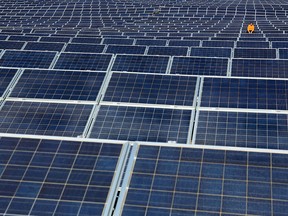 A former lead and zinc mine in southeastern British Columbia has generated a small profit in its first full year of operation as a solar farm. A maintenance man works on solar panels at Norsol solar energy company in Villaldemiro, northern Spain in this file photo.
