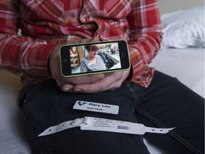 Andrew Grimeau, the adopted son of Mary Louise Murphy, sits on her bed where she died after being released from the ER at Abbotsford Regional hospital.