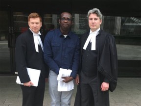 Solomon Akintoye with lawyers Doug King, left, and Neil Chantler, right.