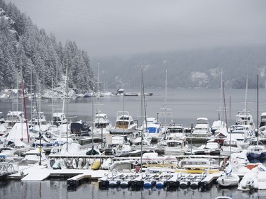 Boats are covered in snow after a snowstorm hit North Vancouver, B.C., Friday, Feb. 3, 2017.