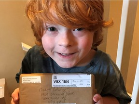 Everett Botwright holds a package addressed to him in Nanaimo, B.C. containing Star Wars Kraft Dinner in a family handout photo.