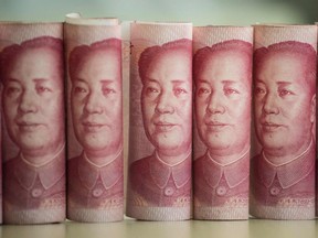 This photo illustration shows Chinese 100 yuan notes.