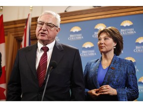 Premier Christy Clark looks on as British Columbia's Trade Envoy to the United States David Emerson speaks to media following a special cabinet meeting to discuss the softwood lumber dispute at Legislature on Thursday, February 16, 2017 in Victoria, B.C.