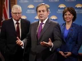 Canada's Ambassador to the United States David McNaughton speaks to media as B.C. envoy to the United States David Emerson and Premier Christy Clark look on following a special cabinet meeting to discuss the softwood lumber dispute.