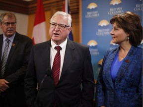 Minister Steve Thomson, (left), and Premier Christy Clark look on as British Columbia's Trade Envoy to the United States David Emerson speaks to media following a special cabinet meeting to discuss the softwood lumber dispute at Legislature on Thursday, February 16, 2017 in Victoria, B.C.