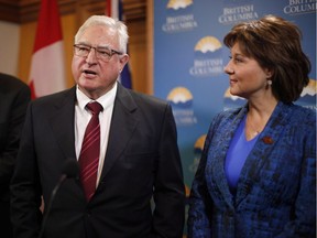 A Kelowna woman has been charged with threatening Premier Christy Clark (right) and Speaker Steve Thomson