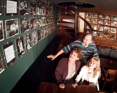 Bill Millerd and actors Janet Wright (lower left) and Margaret Bard share some laughs in 1995 looking at photos from the Seymour Street days of the Arts Club Theatre.