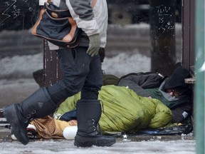 A homeless man sleeps in a doorway in Vancouver's Downtown Eastside in December 2016. Metro Vancouver and the B.C. Non-Profit Housing Association are looking for volunteers to help with this year’s homeless count.